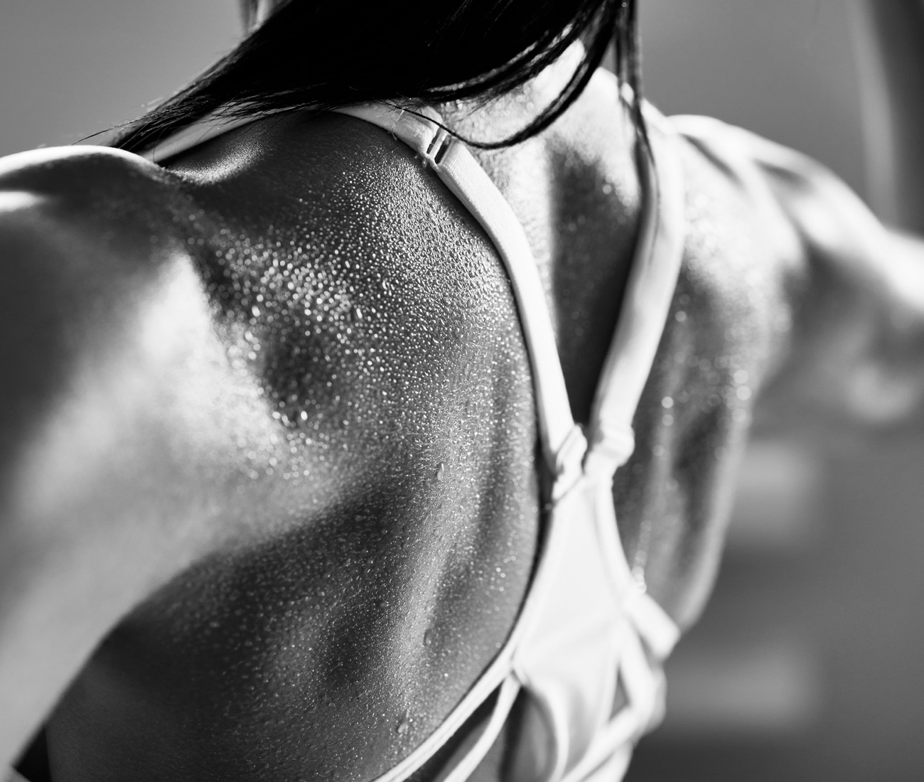 Close Up Of A Woman's Muscular Back In A Bra, Black And White Photo
