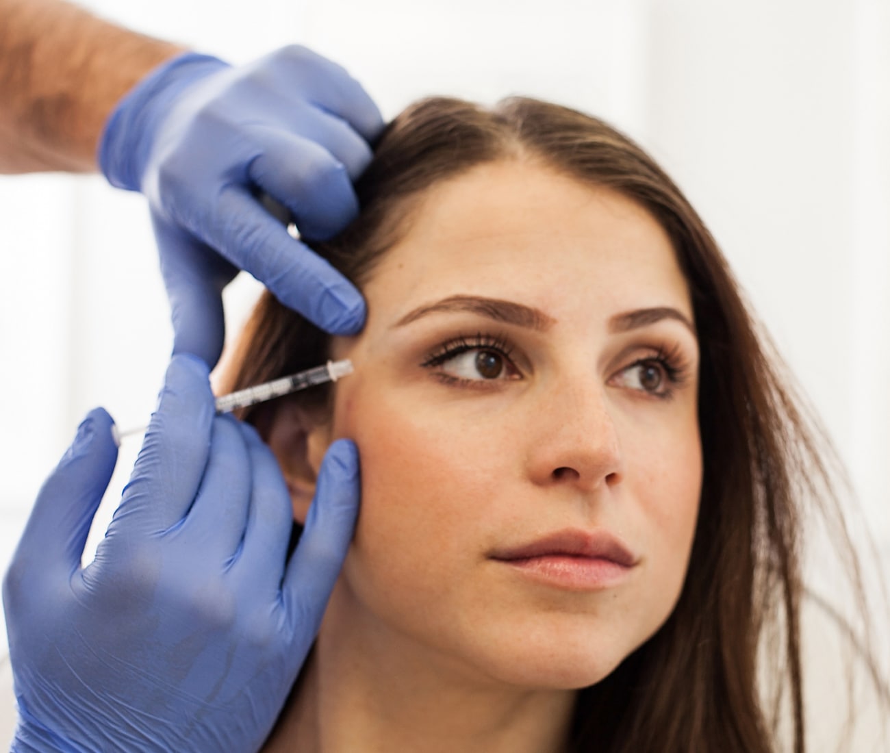 Woman Getting A Botox Injection Next To Her Eye