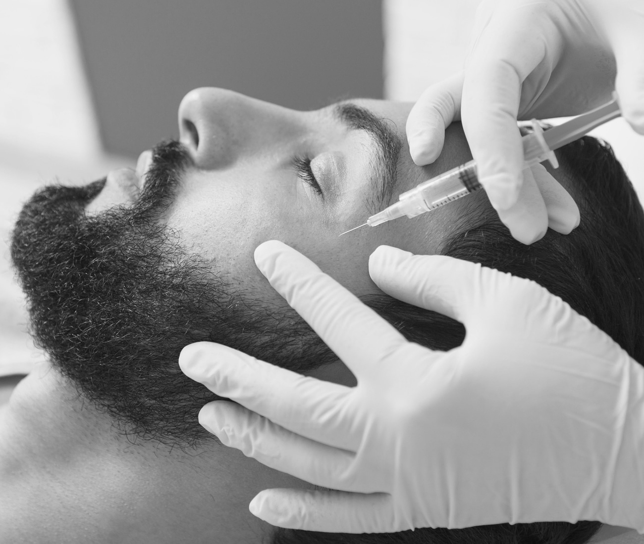 Man With A Beard Getting Botox In His Cheek