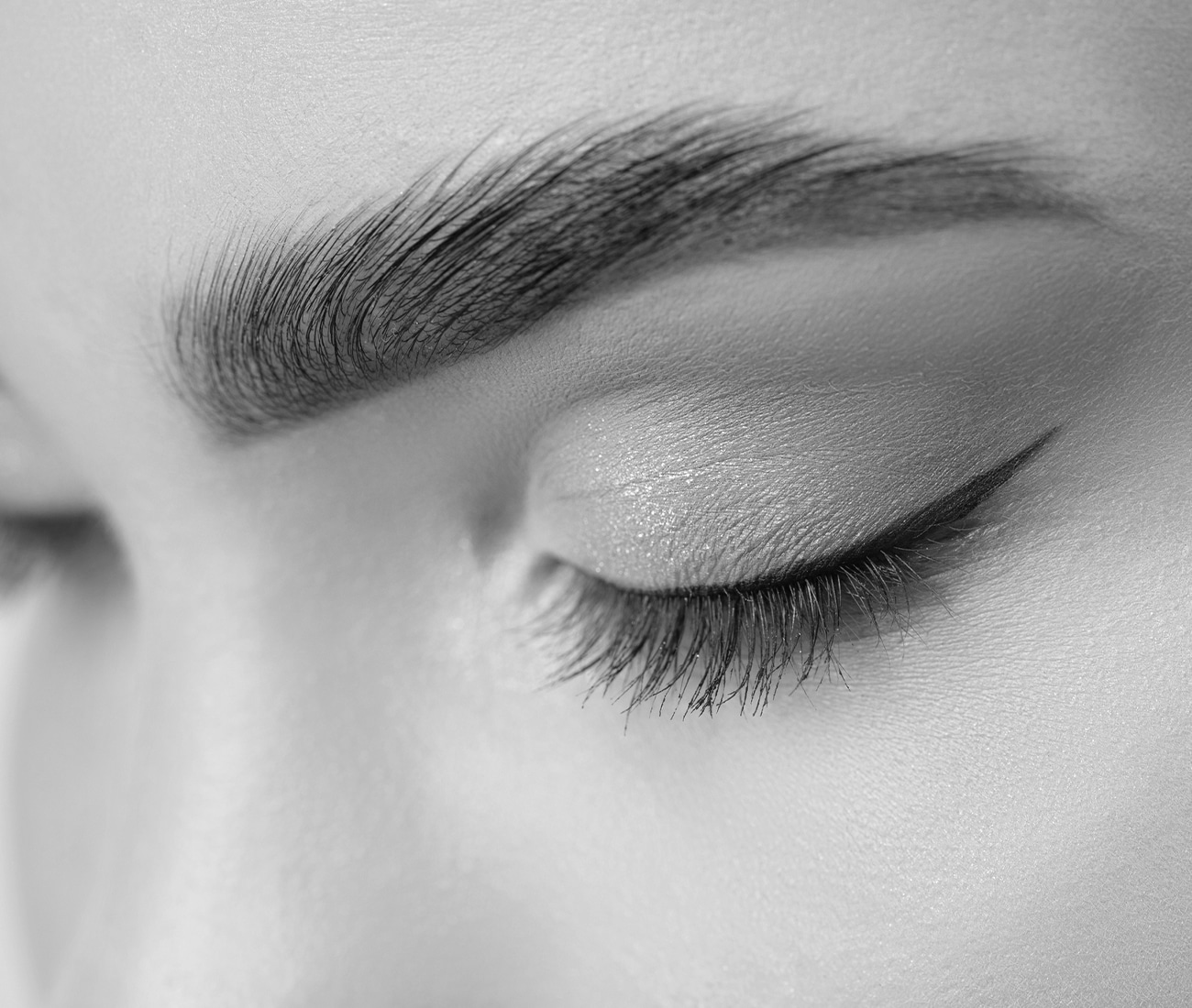 A Close Up Of Woman's Eye Makeup And Eyebrow, Black And White