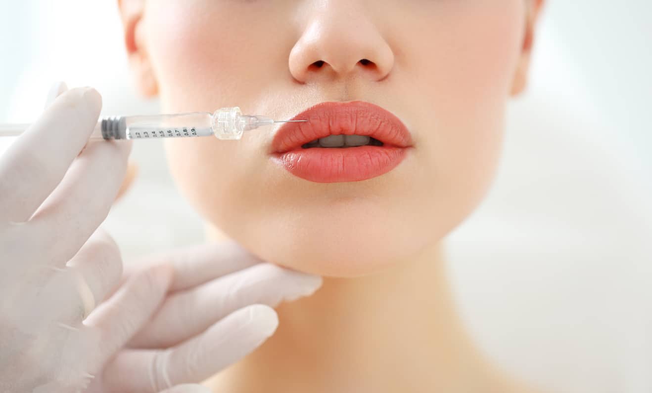 A Woman Receives Dermal Fillers In Her Lip For Beautiful Volume